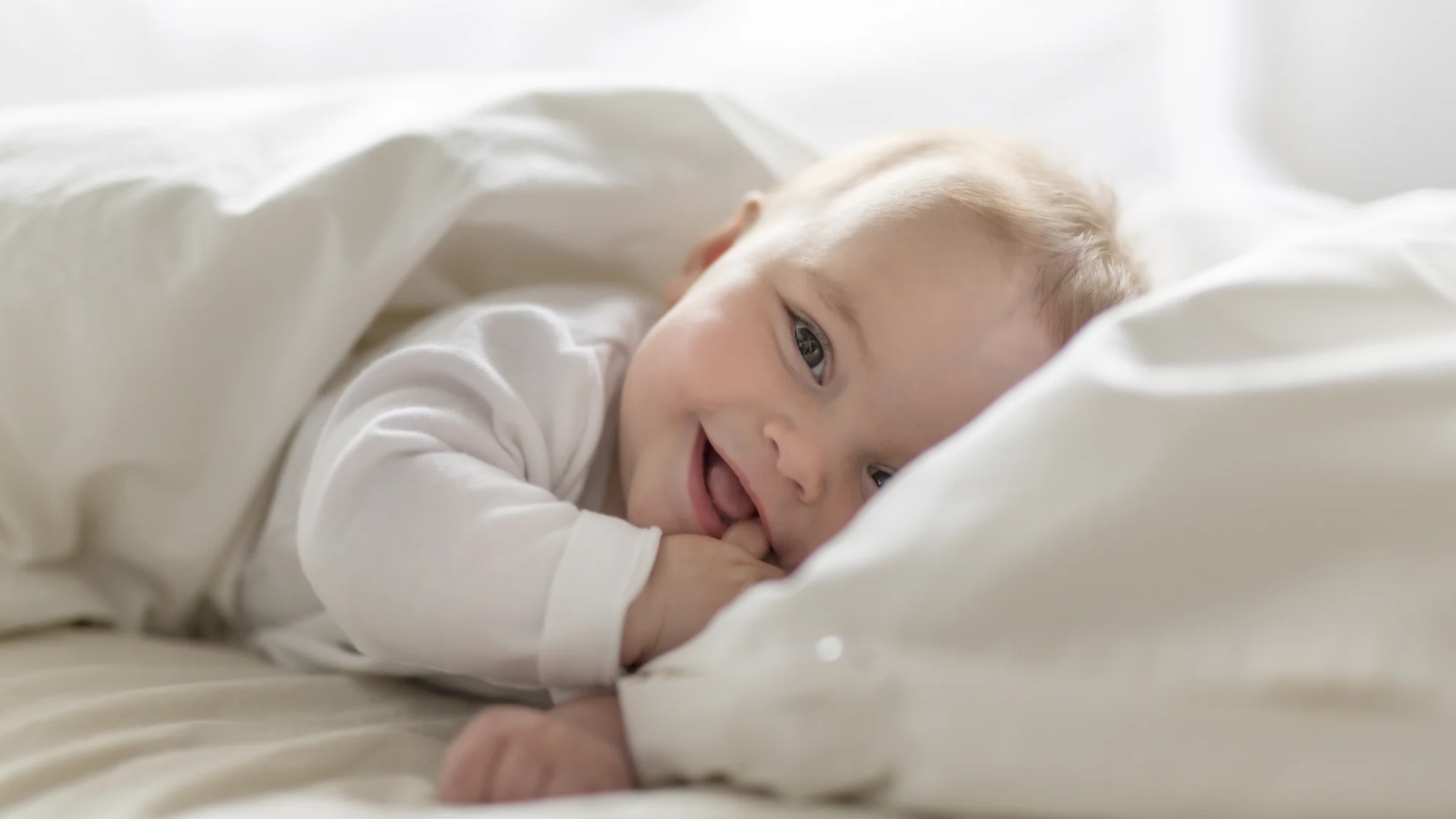 Smiling baby lying on a blanket